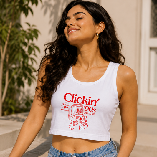 Woman wearing a white tank top with red text and blue jeans, standing outdoors.