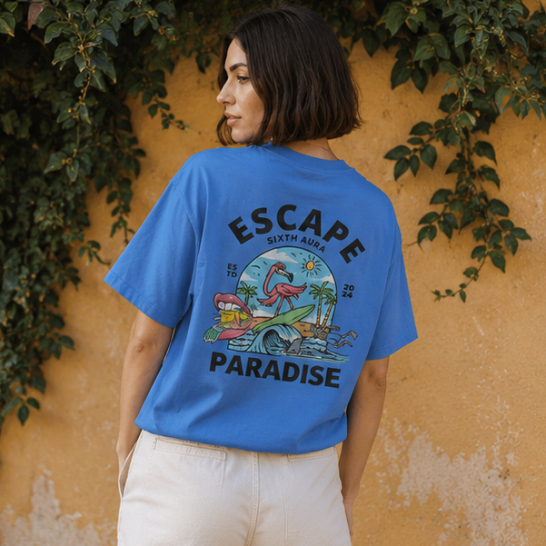 Person wearing a blue t-shirt with 'Escape to Paradise' graphic and text.