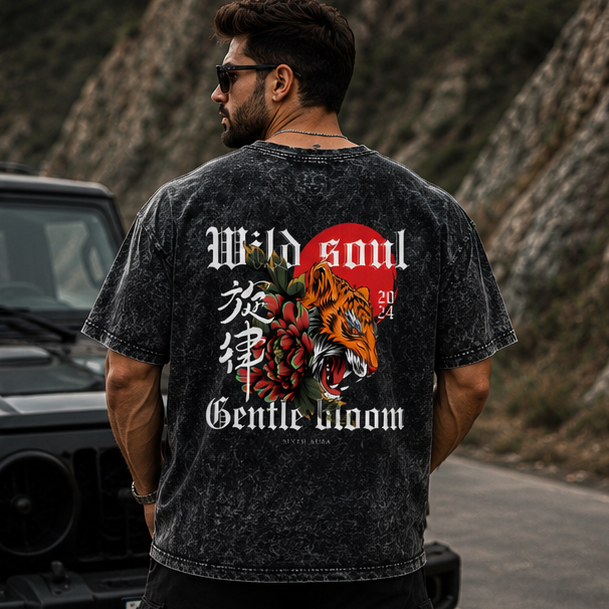 Man wearing a black t-shirt with a colorful design on the back, standing in various outdoor settings.